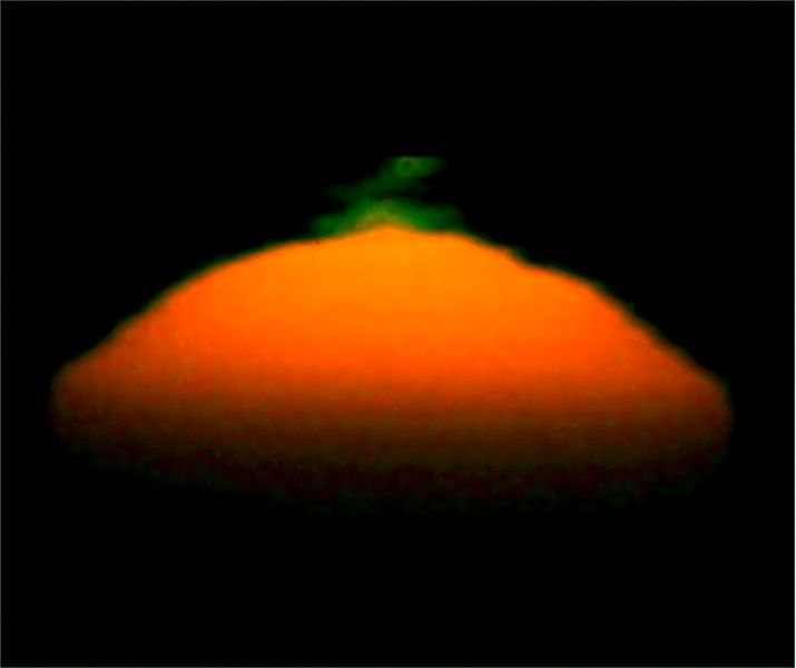 Bright orange-yellow semicircle (the sun) with double elongated green spots at top.