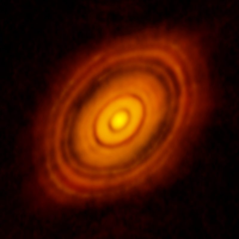 A nearly face-on orange disk of gas and dust, with interesting gaps.