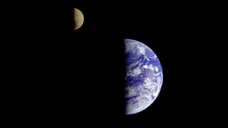 Earth's spin: Right half the moon and right half of the Earth from space. Black background.