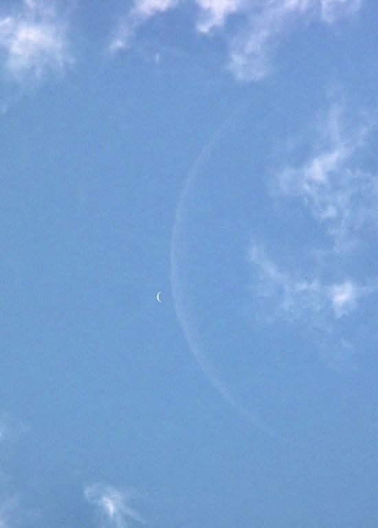 Blue sky with white arc for moon next to white arc for Venus.