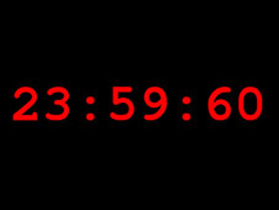 Digital clock with red numerals 23:59:60.