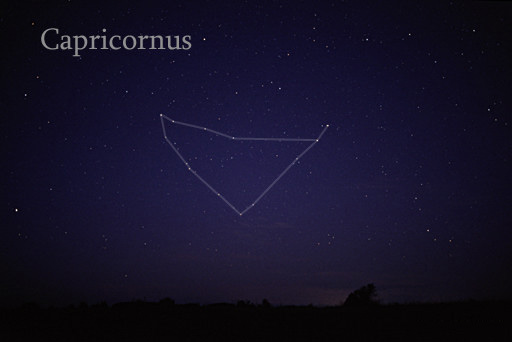 Roughly triangular arrangement of stars with lines between them, against faintly starry sky.