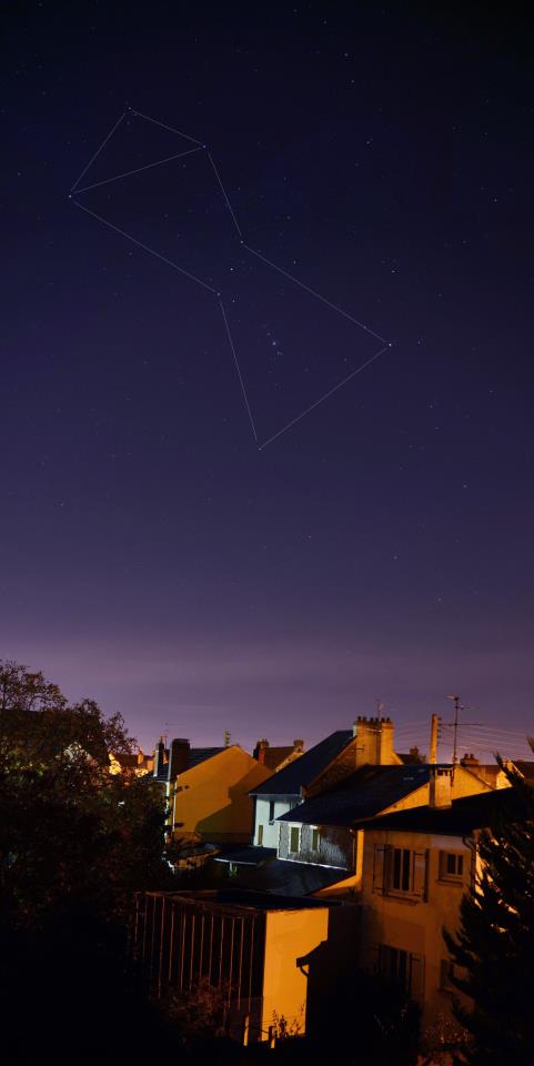 Orion the Hunter constellation with lines connecting the stars in a dark sky.