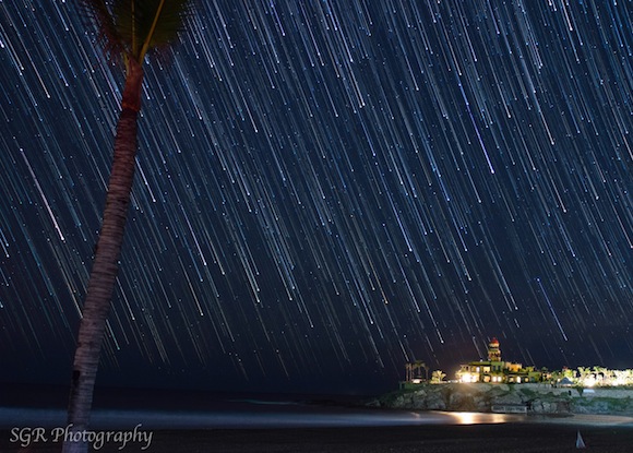 Long white streaks with bright dots at lower end, looking like a rain of stars.