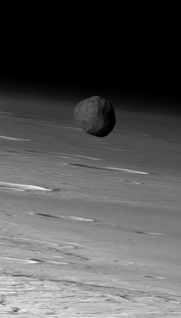 The larger of Mars' two moons, Phobos, orbiting in front of Mars. Image via Mars Express / ESA / DLR / FU Berlin (G. Neukum).