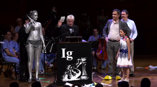 2013 Ig Nobel physics prize winner Alberto Minetti tries to finish his speech despite protests from Miss Sweetie Poo. Image credit: Improbable Research Inc.