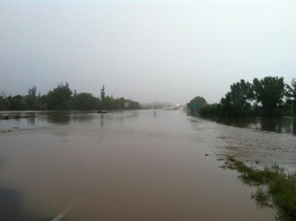 Big Thompson River is now flowing across I-25 shutting it down in both directions. Image Credit: @mikeseidel via Twitter