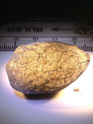 Fragment of Russian meteorite showing shock veins from a previous impact that weakened the rock. Image Credit: Qing-zhu Yin, UC Davis.