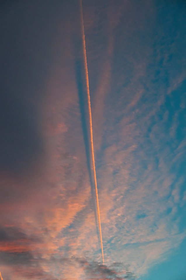 Jet contrail shadow, cast on clouds, by Janet Furlong.
