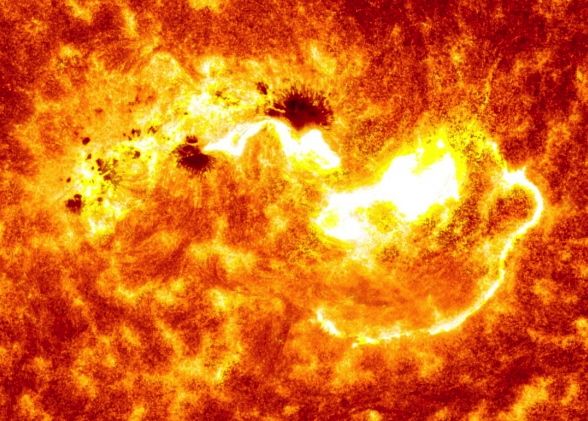 This pictures combines two images from NASA's Solar Dynamics Observatory captured on Jan. 7, 2013. Together, the images show the location of a giant sunspot group on the sun, and the position of an X-class flare that erupted at 1:32 p.m. EST. Image via NASA/SDO 