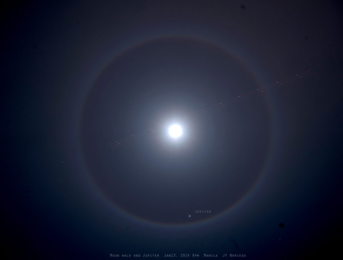 View larger. | Look up! You might see something cool. EarthSky Facebook friend Jv Noriega in the Philippines captured this lunar halo on January 13, 2014. Look closely. An airliner streaks across the halo. At the bottom of the ring is Jupiter! 011314 9pm Manila. Thank you, Jv. See more Jv Noriega photos 