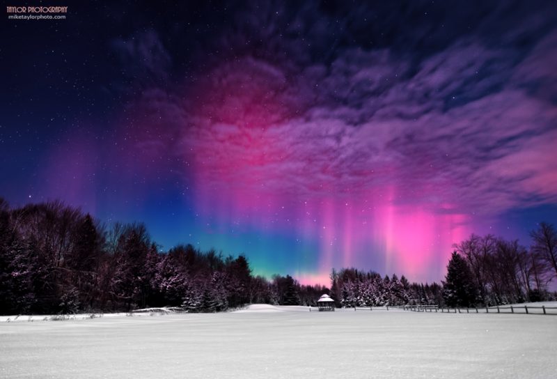 Pink and blue curtains over a snowy landscape.
