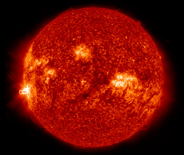The sun released a powerful X-flare on February 25 at 0050 UTC.  Look to the left side of sun, near the sun's limb, for the flare.  Image via NASA SDO