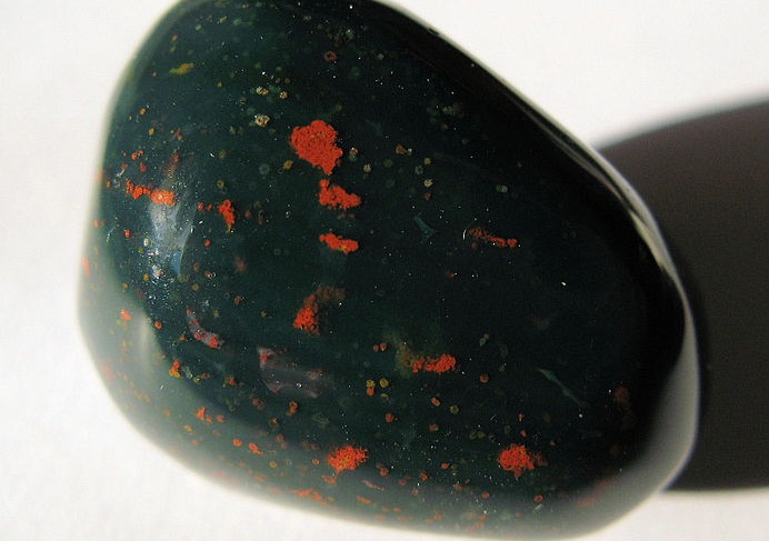 Round black polished rock woth bits of red.