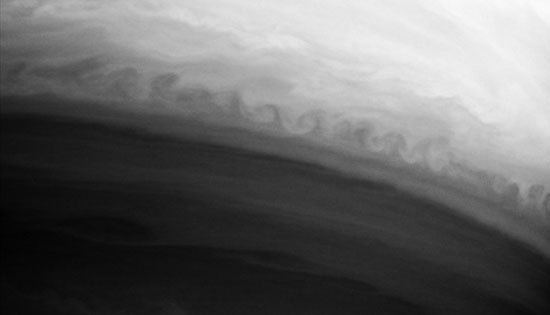 Gray background clouds with row of very round, delicate wave clouds.