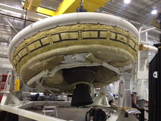 A saucer-shaped test vehicle holding equipment for landing large payloads on Mars is shown in the Missile Assembly Building at the US Navy's Pacific Missile Range Facility in Kaua‘i, Hawaii. Image credit: NASA/JPL-Caltech