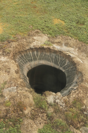 The first mysterious crater spotted by helicopter in the Yamal region of northern Russia.  Image via Nature.