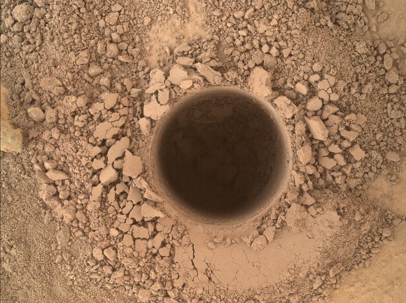 This image from the Mars Hand Lens Imager (MAHLI) camera on NASA's Curiosity Mars rover shows the first sample-collection hole drilled in Mount Sharp, the layered mountain that is the science destination of the rover's extended mission. Image credit: NASA/JPL-Caltech/MSSS