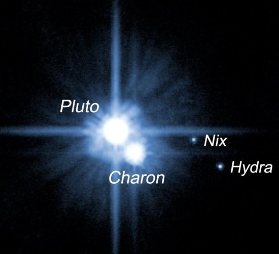 This 2005 image shows Pluto and four of its five known moons, as seen by the Hubble Space Telescope.  Image via HubbleSite