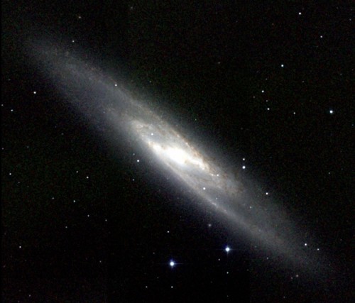 The sculptor galaxy - also known as NGC 253 - is an example of a disk galaxy.  It has a flat, circular disk containing gas, dusk and most of the galaxy's stars.  Image via Wikimedia Commons.