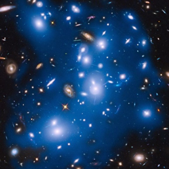 Massive galaxy cluster Abell 2744, nicknamed Pandora's Cluster, takes on a ghostly look where total starlight has been artificially colored blue in this Hubble view.  Image via NASA/ESA/IAC/HFF Team, STScI