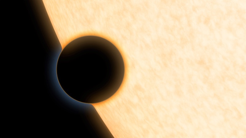 Planet silhouetted against the bright surface of its sun.