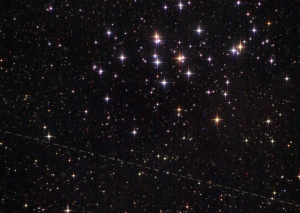 Star field with scatter of extra-bright stars and a line across it.