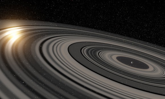 Artist’s conception of the extrasolar ring system circling the young giant planet or brown dwarf J1407b. The rings are shown eclipsing the young sun-like star J1407, as they would have appeared in early 2007.  Image credit: Ron Miller