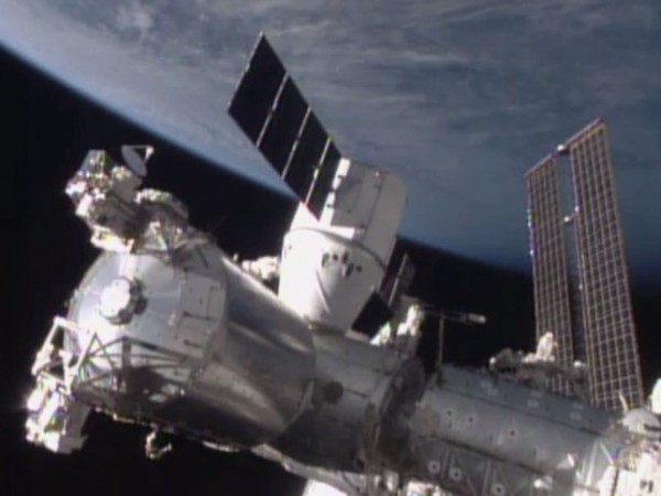 The SpaceX Dragon cargo spacecraft was berthed to the Harmony module of the International Space Station at 8:54 a.m. EST. The hatch between the newly arrived spacecraft and the Harmony module of the space station is scheduled to be opened Tuesday, but could occur earlier. The capsule is scheduled to spend four weeks attached to the station.  Image via NASA
