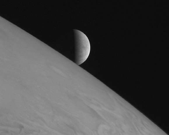 Europa rising above Jupiter's cloudtops, as captured by the New Horizons spacecraft - en route to Pluto - in 2007.  Image via NASA.