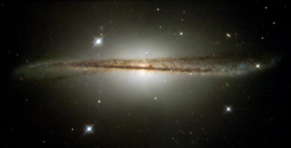 Warped, edge-on spiral galaxy ESO 510-G13, as captured by the Hubble Space Telescope in 2001. Read more about this image