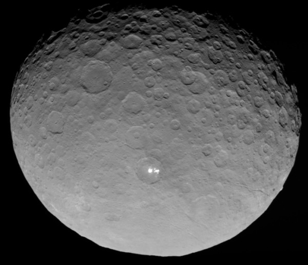 In this closest-yet view, the brightest spots within a crater in the northern hemisphere of the dwarf planet Ceres are revealed to be composed of many smaller spots. Their exact nature remains unknown.  Image via NASA Dawn mission.