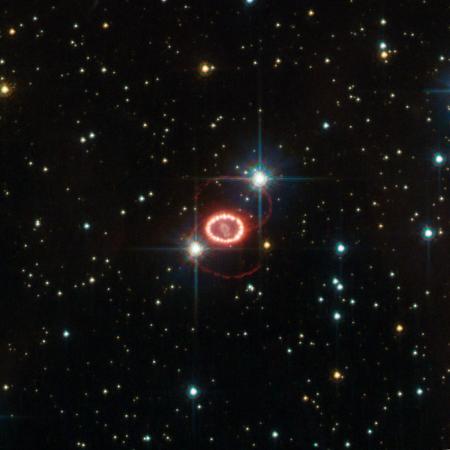 The still unraveling remains of supernova 1987A are shown here in this image taken by NASA's Hubble Space Telescope. The bright ring consists of material ejected from the dying star before it detonated. The ring is being lit up by the explosion's shock wave. Image credit: ESA/Hubble & NASA