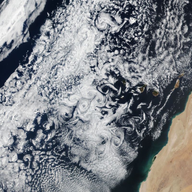 Swirling white clouds seen from space alongside the northern African continent.