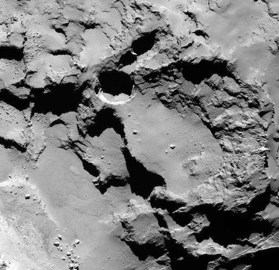 This close-up image shows the most active pit, known as Seth_01, observed on the surface of comet 67P/Churyumov-Gerasimenko by the Rosetta spacecraft. A new study suggests that this pit and others like it could be sinkholes, formed by a surface collapse process similar to the way these features form on Earth. Image via Vincent et al., Nature Publishing Group