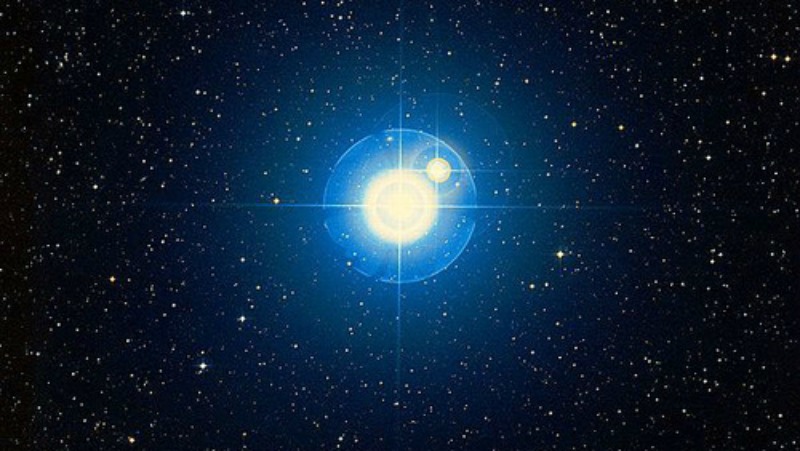 Brilliant star with lens rays accompanied by very close smaller star.