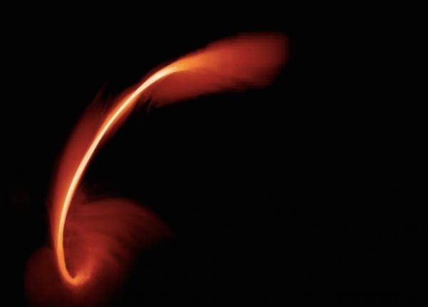 A snapshot image from a computer simulation of a star disrupted by a supermassive black hole. The red-orange plumes show ... [more] Image courtesy of J. Guillochon (Harvard University) and E. Ramirez-Ruiz (University of California at Santa Cruz)