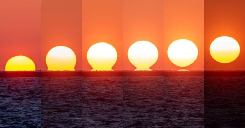 A series of photos of the sunrise, over water, where the bottom of the sun seems to "stick" to the water.