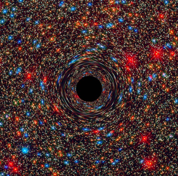 This computer-simulated image shows a supermassive black hole at the core of a galaxy. The black region in the center represents the black hole’s event horizon, where no light can escape the massive object’s gravitational grip. The black hole’s powerful gravity distorts space around it like a funhouse mirror. Light from background stars is stretched and smeared as the stars skim by the black hole. Image credit: NASA, ESA, and D. Coe, J. Anderson, and R. van der Marel (STScI) 