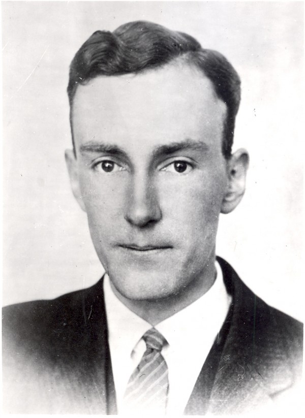 Black and white image of man in suit and tie.