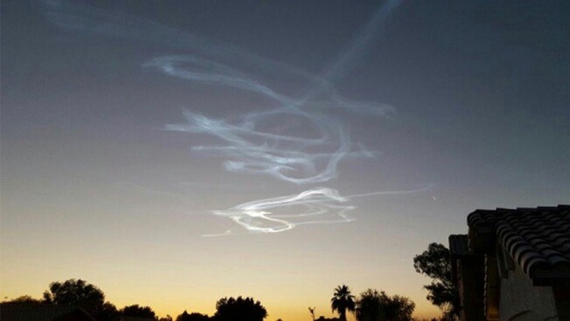 Twisty, overlapping smoke trail scribbled across the sky.