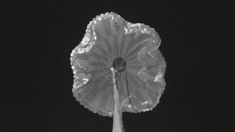 Animated view of a parachute opening, seen from below.