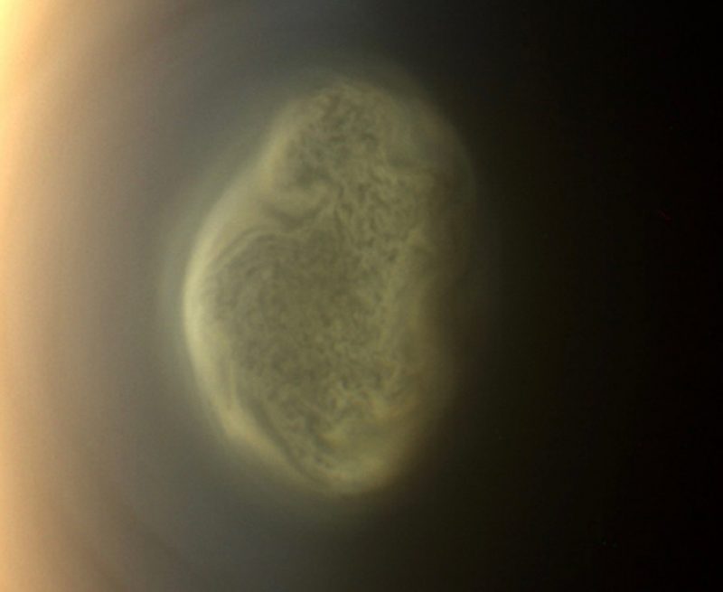 This true color image captured by NASA'S Cassini spacecraft before a distant flyby of Saturn's moon Titan on June 27, 2012, shows a south polar vortex, or a mass of swirling gas around the pole in the atmosphere of the moon. 