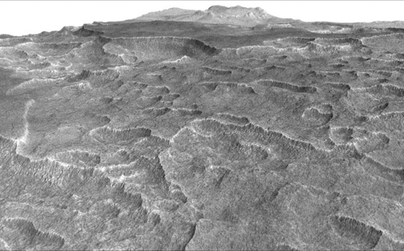 This vertically exaggerated view shows scalloped depressions in a part of Mars where such textures prompted researchers to check for buried ice, using ground-penetrating radar aboard NASA's Mars Reconnaissance Orbiter. Image via NASA/JPL-Caltech/Univ. of Arizona