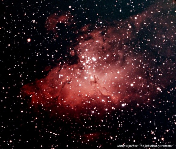 Reddish nebula with many stars in background.