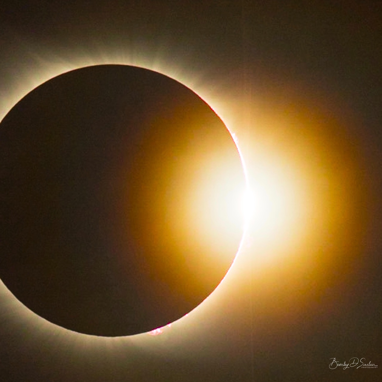 A totally eclipsed sun with a bright light emerging on one side: the diamond ring effect.