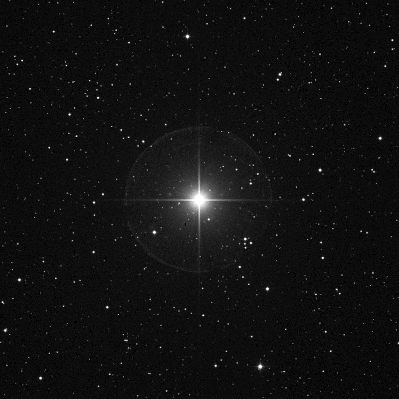 Gamma Cephei: Large bright star with lens rays on black field with scattered stars.