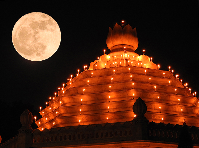 Hunter's Moon: Big, round, white full moon above temple with candles around every floor and onion dome on top.