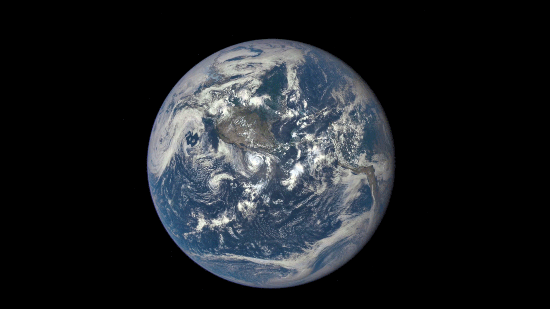 Animated photo of gray ball passing in front of blue and white Earth.