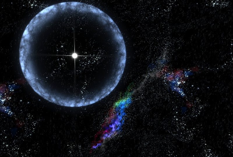 Blue ring around brilliant white star, wisps of colorful gas outside ring.